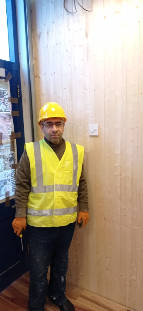 Portrait of the Afsin Services handyman in hi-vis PPE, ready for the next job.