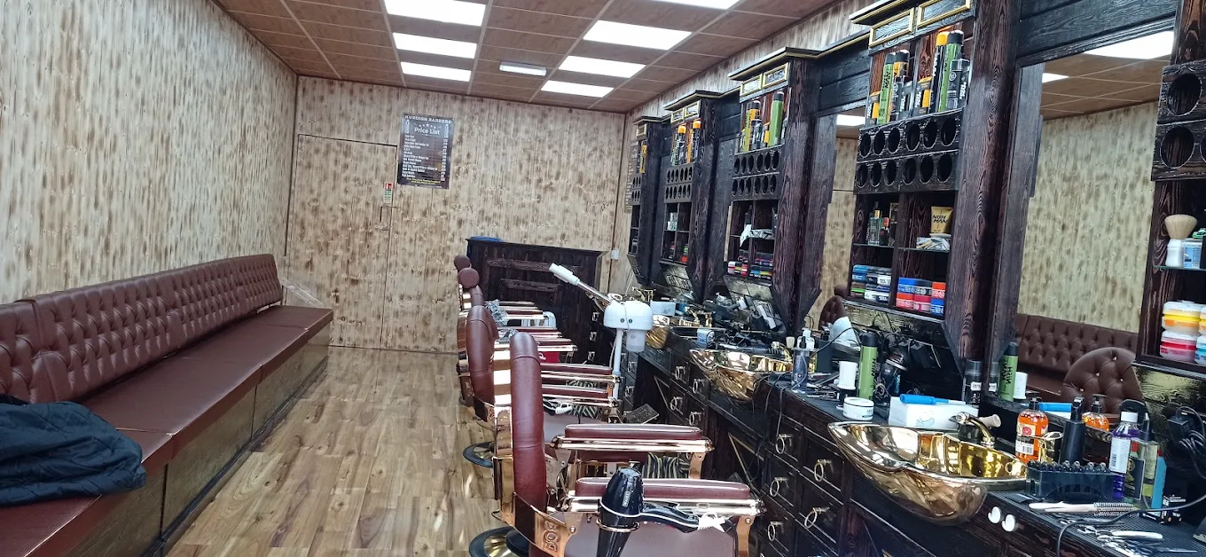 Wide interior view of the completed barbershop with wooden panelling and leather seating.