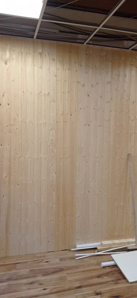 Finished timber wall cladding installed floor to ceiling inside the shop.